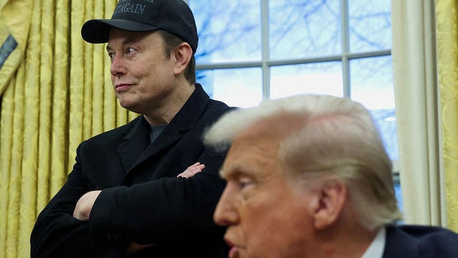 <div class="paragraphs"><p>Elon Musk listens to US President Donald Trump </p></div>