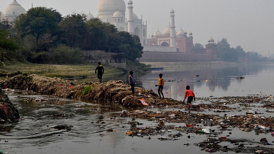 <div class="paragraphs"><p>Children play on a dirty silt frozen in the Yamuna River behind Taj Mahal, in Agra.</p></div>