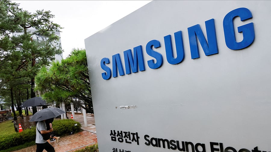 <div class="paragraphs"><p>A man walks past a signboard of Samsung Electronics in front of the Samsung Electronics Nano City Hwaseong Campus in Hwaseong, South Korea</p></div>