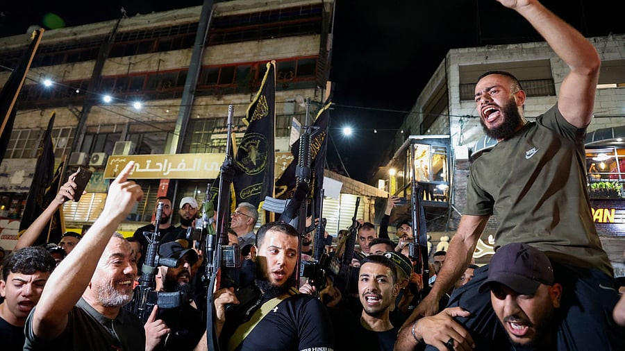 <div class="paragraphs"><p>Palestinian gunmen attend a protest against the killing of Palestinians in an Israeli strike at a tent camp, amid Israel-Hamas conflict, in the streets of Jenin, in the Israeli-occupied West Bank.</p></div>