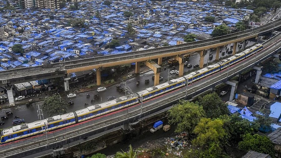 <div class="paragraphs"><p>A metro train near Dahisar slum in Mumbai.&nbsp;</p></div>