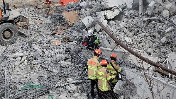 <div class="paragraphs"><p>Rescue workers participate in a salvage operation at a collapsed highway construction site in South Korea</p></div>