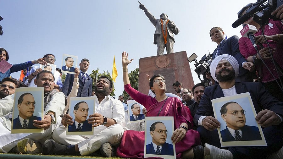 <div class="paragraphs"><p>Leader of Opposition in the Delhi Assembly Atishi with other AAP MLAs stages a protest over removal of BR Ambedkar's potraits from CM office, during the first session of Delhi Assembly, in New Delhi.</p></div>