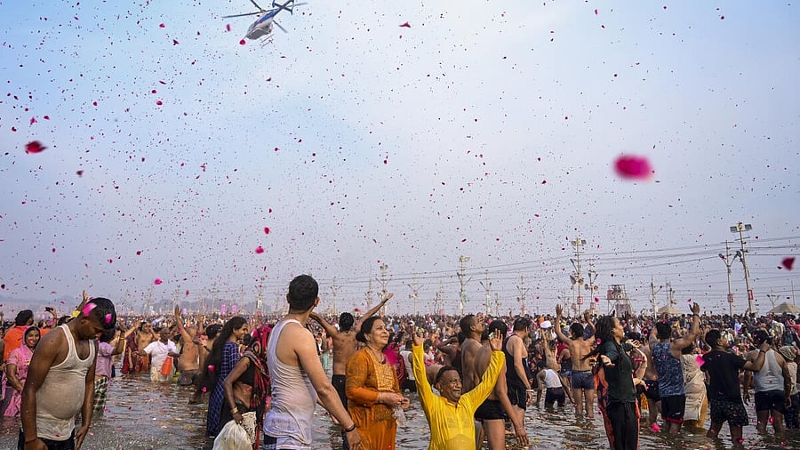 <div class="paragraphs"><p>A helicopter showers flower petals on devotees taking holy dip at Sangam on the occasion of Maha Shivratri during the Maha Kumbh Mela</p></div>