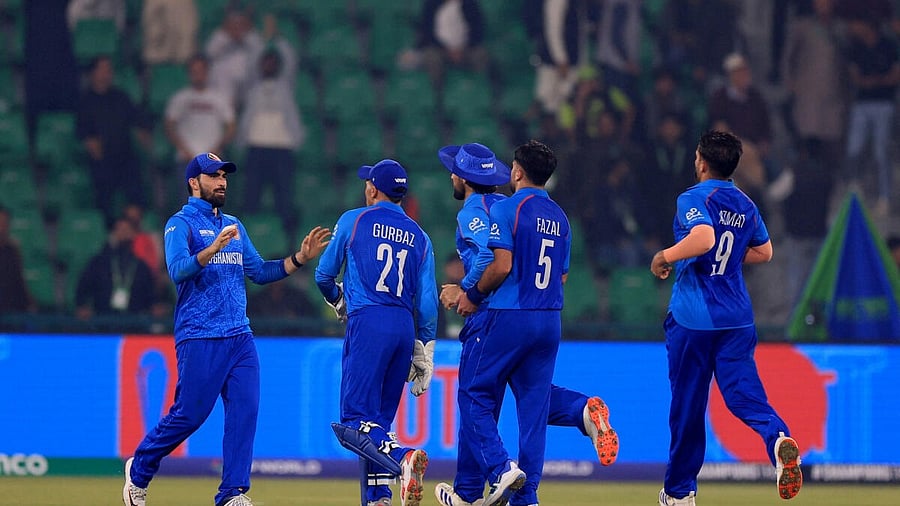 <div class="paragraphs"><p>Afghanistan's Mohammad Nabi and Fazalhaq Farooqi celebrate taking the wicket of England's Jofra Archer with teammates</p></div>