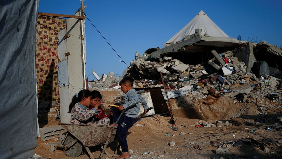 <div class="paragraphs"><p>Children play near the rubble of destroyed buildings</p></div>