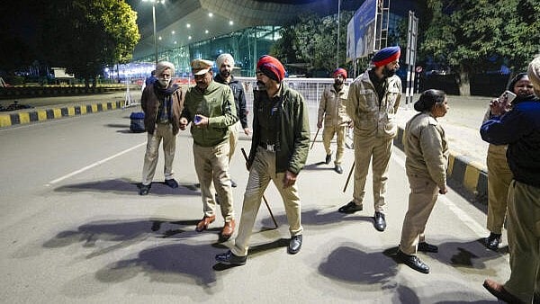 <div class="paragraphs"><p>Security personnel outside the airport ahead of the second batch of the immigrants' arrival from the US.</p></div>
