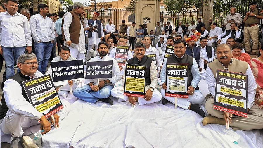 <div class="paragraphs"><p>Rajasthan Congress President Govind Singh Dotasra, Leader of Opposition Tikaram Jully and party MLAs sit on dharna as they protest outside the state Assembly against suspension of their MLAs from the Assembly and against a state minister's alleged remarks against former prime minister Indira Gandhi, in Jaipur, Thursday, Feb. 27, 2025.</p></div>