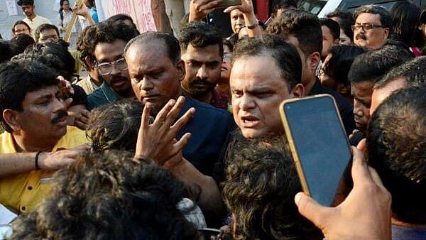 <div class="paragraphs"><p>West Bengal Education Minister Bratya Basu, centre, speaks with Students' Federation of India (SFI) members at Jadavpur University campus, in Kolkata, Saturday.&nbsp;</p></div>