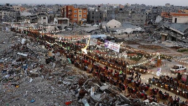 <div class="paragraphs"><p>Palestinians break their fast by eating the Iftar meals during the holy month of Ramadan, near the rubble of buildings, amid a ceasefire between Israel and Hamas, in Rafah, in the southern Gaza Strip, March 1, 2025.</p></div>