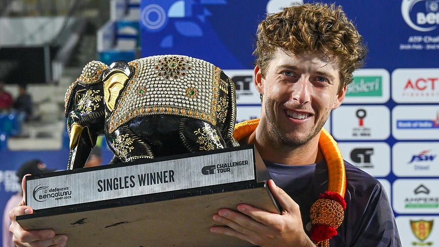 <div class="paragraphs"><p>US’ Brandon Holt celebrates with the Bengaluru Open title at the KSLTA Courts on Sunday.</p></div>