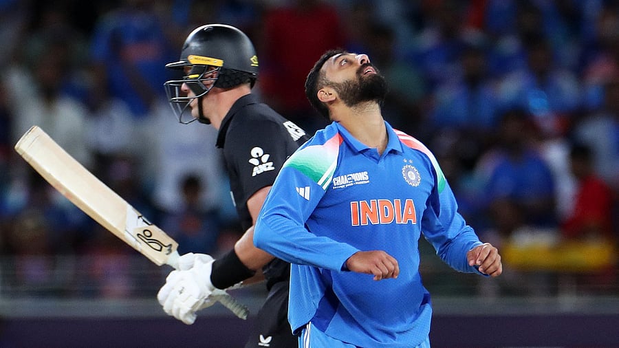 <div class="paragraphs"><p> Varun Chakravarthy celebrates after taking the wicket of New Zealand's Matt Henry </p></div>
