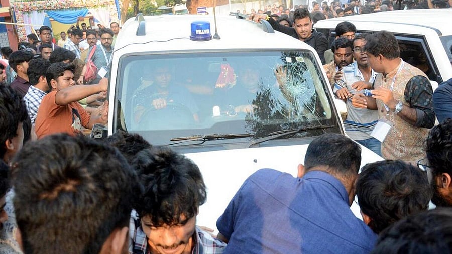 <div class="paragraphs"><p>Students' Federation of India (SFI) members gather around West Bengal Education Minister Bratya Basu's car at Jadavpur University campus, in Kolkata, Saturday, March 1, 2025.</p></div>