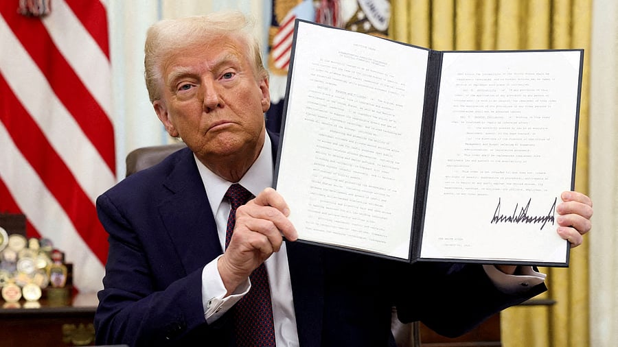 <div class="paragraphs"><p>US President Donald Trump holds a signed executive order on cryptocurrencies, in the Oval Office of the White House, in Washington, U.S</p></div>