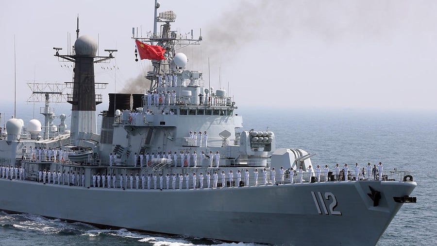 <div class="paragraphs"><p>File photo of Chinese servicemen gesture from the deck of a naval vessel</p></div>
