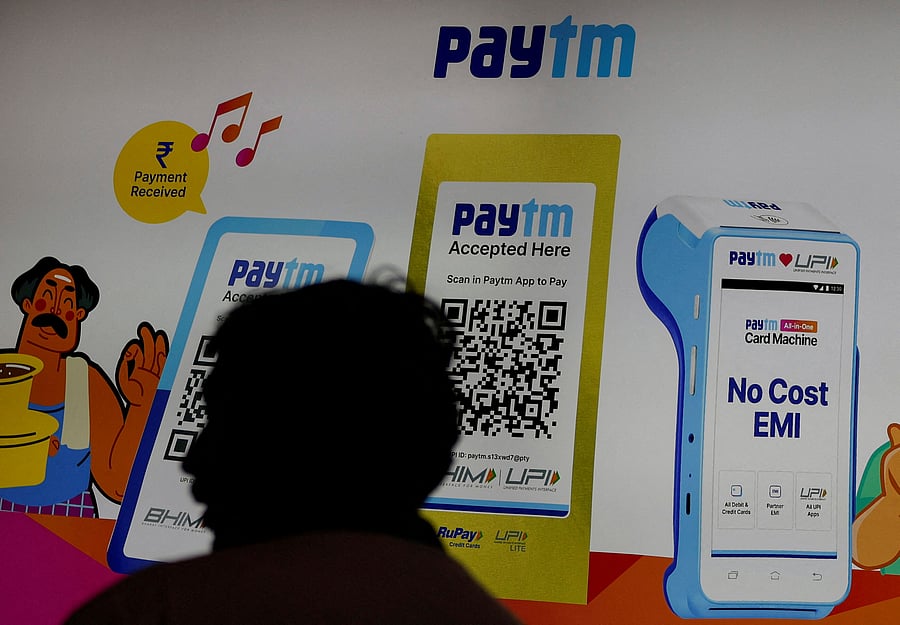<div class="paragraphs"><p>A man stands at a Paytm stall </p></div>