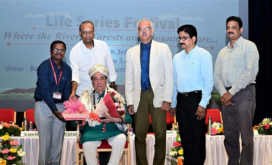 <div class="paragraphs"><p>Centre for Environment Education  Chairman Ashok Khosla being honoured at the inaugural ceremony of the&nbsp;five-day ‘Life Series Festival' on Kuvempu University campus near Shivamogga on Monday. Kuvempu University&nbsp;Vice-Chancellor Sharath Ananthamurthy and others are seen. </p><p></p></div>