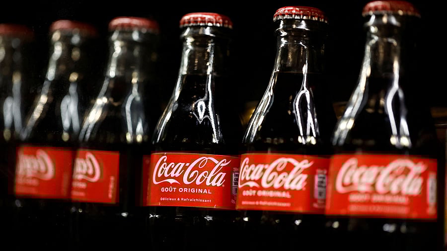 <div class="paragraphs"><p>Bottles of Coca-Cola are displayed on a shelf in a supermarket.</p></div>