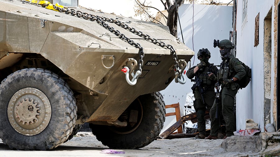 <div class="paragraphs"><p>Israeli soldiers stand next to a military vehicle during an Israeli raid in Jenin, in the Israeli-occupied West Bank, March 4, 2025.</p></div>