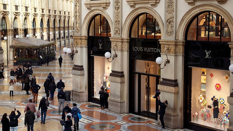 <div class="paragraphs"><p>People walk outside a Louis Vuitton store in Italy.</p></div>