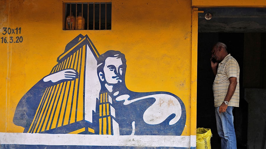 <div class="paragraphs"><p>A dealer selling Ambuja cement speaks on his phone at his shop in Ahmedabad.</p></div>