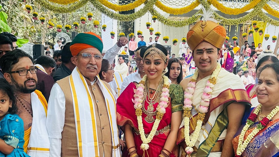 <div class="paragraphs"><p>Groom BJP MP Tejasvi Surya with bride, Carnatic singer Sivasri Skandaprasad with wedding guest Union Minister&nbsp;Arjun Ram Meghwal</p></div>