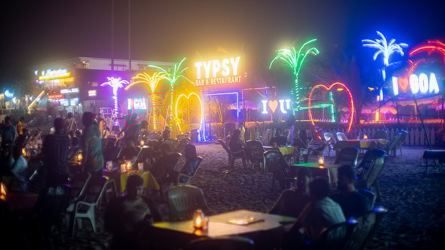 <div class="paragraphs"><p>Tourists at a beachside shack in Goa</p></div>