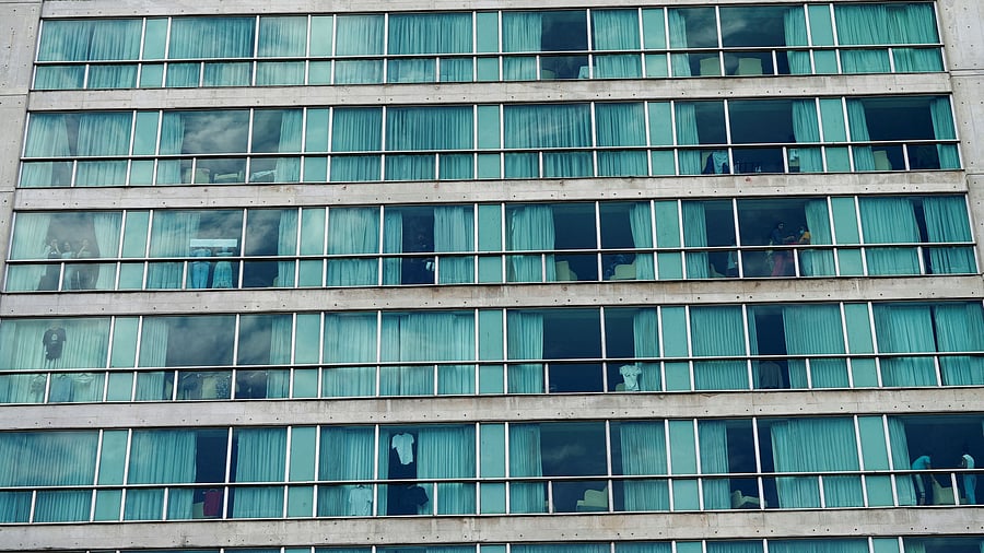 <div class="paragraphs"><p>People look out from a hotel where migrants from Asia and the Middle East are housed after being deported to Panama as part of an agreement between the administration of US President Donald Trump and the Central American nation, in Panama City, Panama.</p></div>