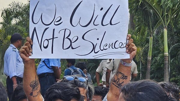<div class="paragraphs"><p>An agitator holds a poster during a protest over the death of a Nepali student on the Kalinga Institute of Industrial Technology (KIIT)</p></div>
