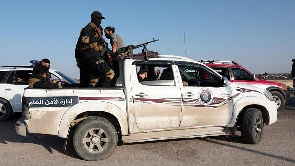 <div class="paragraphs"><p>Syrian army personnel travel in a military vehicle as they head towards Latakia to join the fight against the fighters linked to Syria's ousted leader Bashar al-Assad, in Aleppo</p></div>