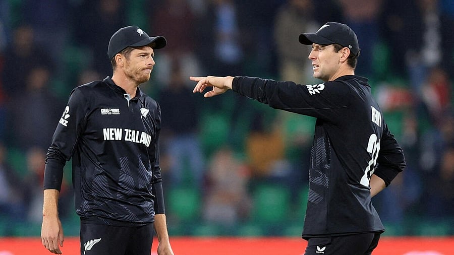 <div class="paragraphs"><p>New Zealand's Mitchell Santner interacts with Matt Henry.</p></div>