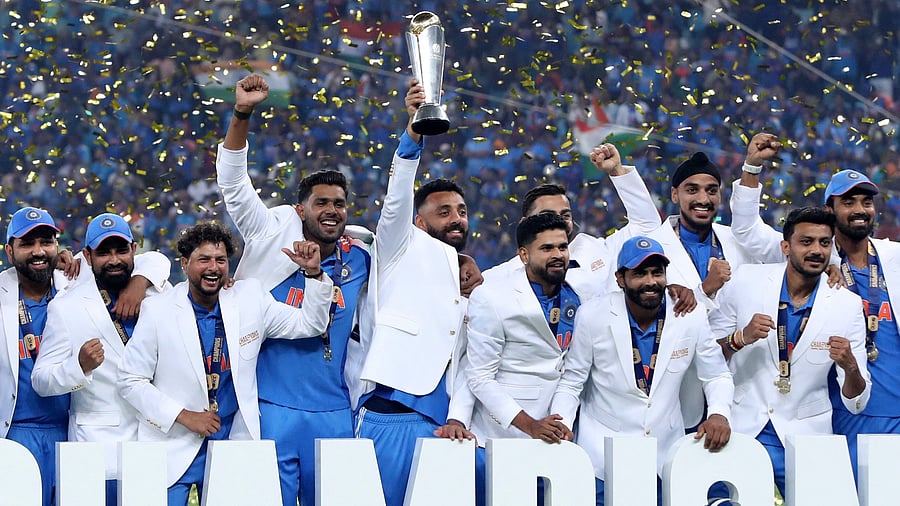 <div class="paragraphs"><p>Indian players celebrate on the podium with the trophy after defeating New Zealand in the final of the Champions Trophy in Dubai on Sunday. </p></div>
