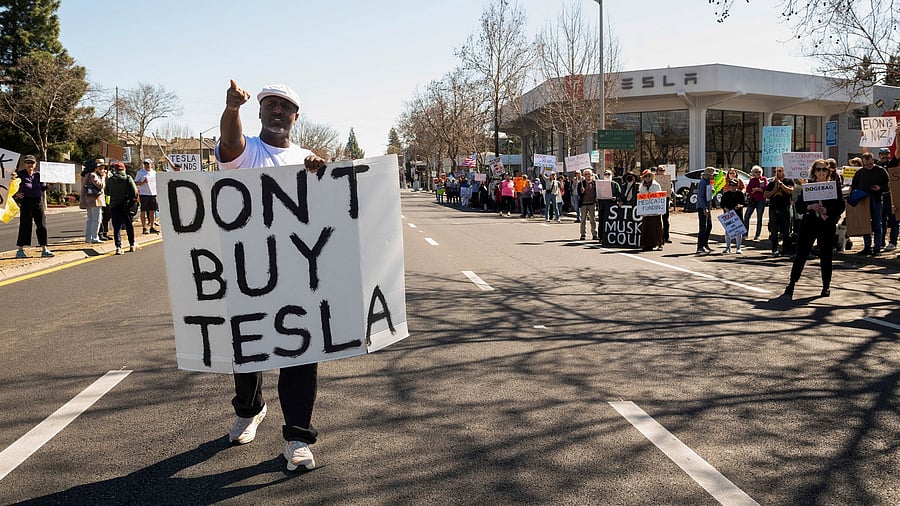 <div class="paragraphs"><p>People protest against Tesla and Elon Musk outside of a Tesla dealership in Palo Alto, California, March 8, 2025. </p></div>
