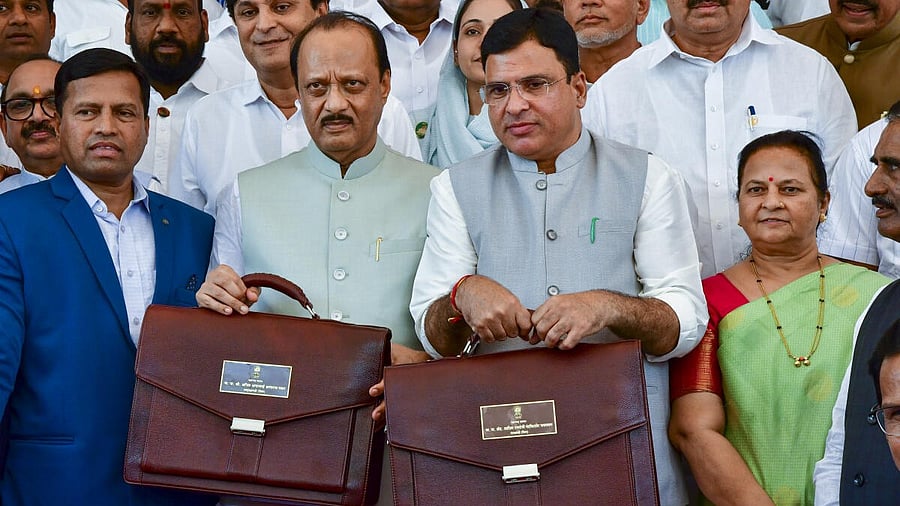 <div class="paragraphs"><p>Maharashtra Deputy Chief Minister Ajit Pawar (second left) and Minister of State for Finance Ashish Jaiswal arrive to present the state Budget </p></div>
