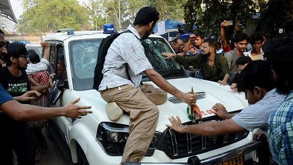 <div class="paragraphs"><p>Students' Federation of India (SFI) members gather around West Bengal Education Minister Bratya Basu's car at Jadavpur University campus, in Kolkata, Saturday, March 1, 2025.</p></div>