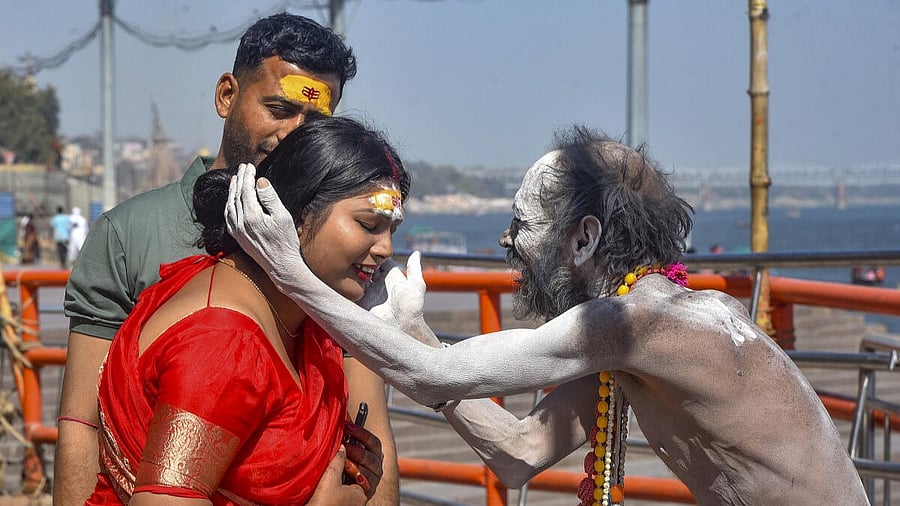 <div class="paragraphs"><p>A devotee seeks blessings of a Naga Sadhu on the bank of the Ganga river in Varanasi.</p></div>
