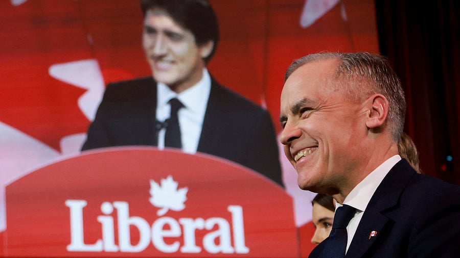 <div class="paragraphs"><p>Mark Carney listens as Canadian Prime Minister Justin Trudeau speaks on the day members of Canada's Liberal Party gather to choose a successor to Trudeau, in Ottawa, Ontario, Canada, March 9, 2025. </p></div>