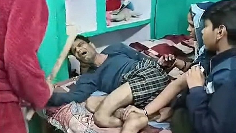 <div class="paragraphs"><p>A chilling video, believed to be shot on February 1, surfaced on social media. The clip shows Maurya's wife holding his legs while his two daughters are beating him with sticks.</p></div>