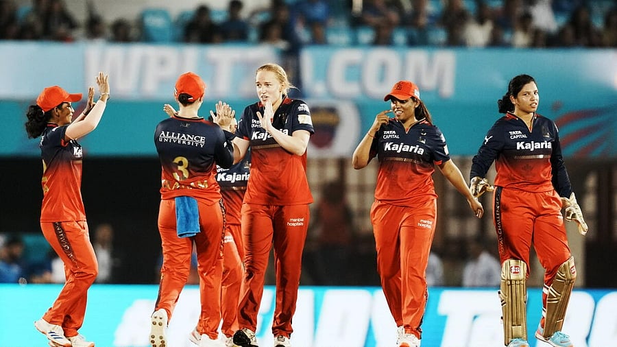 <div class="paragraphs"><p>Royal Challengers Bengaluru players celebrate the wicket of Mumbai Indians' Harmanpreet Kaur during the Women's Premier League (WPL) 2025 cricket match between Royal Challengers Bengaluru and Mumbai Indians, in Mumbai, Tuesday, March 11, 2025.</p></div>