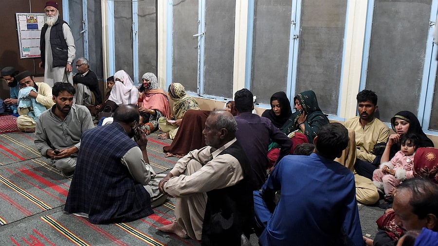 <div class="paragraphs"><p>Passengers, who were rescued from a train after it was attacked by separatist militants, sit at the Mach Railway Station in Mach, Balochistan, Pakistan, March 11, 2025.</p></div>