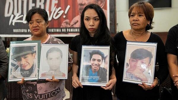 <div class="paragraphs"><p>Relatives hold pictures of drug war and extrajudicial killing victims during a press conference following the arrest of former Philippine President Rodrigo Duterte, in Quezon City, Metro Manila, Philippines, on March 12</p></div>