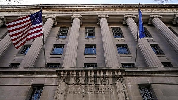 <div class="paragraphs"><p>A flag flies from the Department of Justice in Washington, US.</p></div>