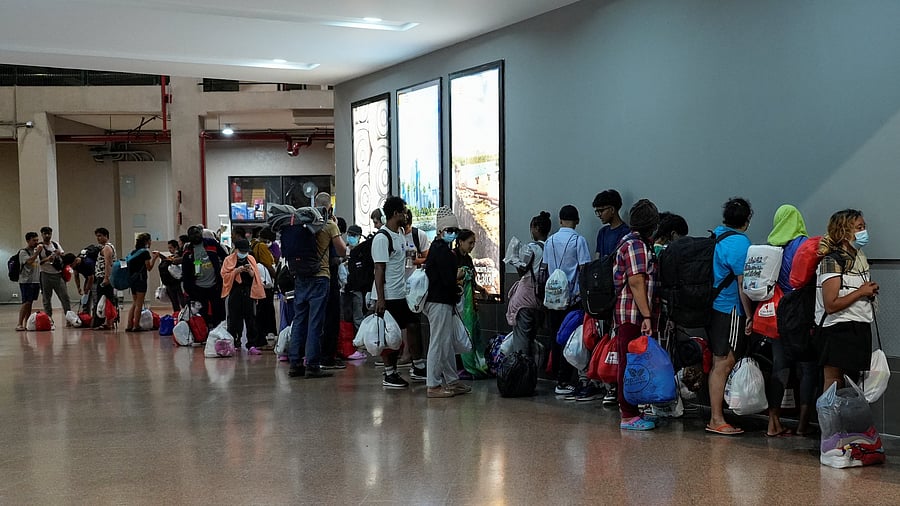 <div class="paragraphs"><p>A group of migrants deported as part of an agreement between the administration of US President Donald Trump and Panama, line up before heading to a hotel where they will stay tonight, following a decision by Panama to issue temporary permits for some migrants recently sent from the US allowing them to stay for up to 90 days, in Panama City, Panama. March 9, 2025. </p></div>