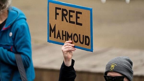 <div class="paragraphs"><p>A person holds a sign in support of Mahmoud Khalil as demonstrators gather to protest in support of causes that include the Palestinians, immigration, labor, and the environment, at the University of Washington in Seattle, Washington.</p></div>
