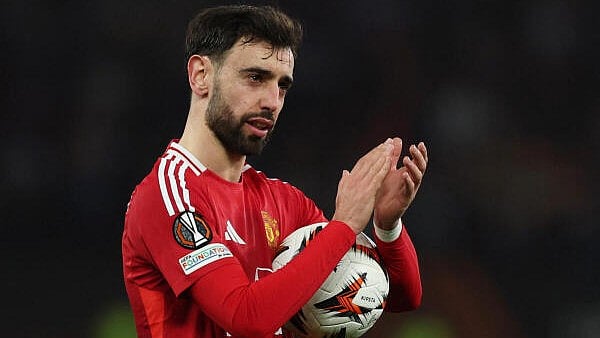 <div class="paragraphs"><p>Manchester United's Bruno Fernandes celebrates with the match ball after the match after scoring a hat-trick</p></div>