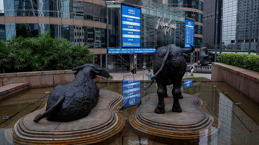 <div class="paragraphs"><p>Bull statues are placed in font of screens showing the Hang Seng stock index and stock prices outside Exchange Square, in Hong Kong, China</p></div>