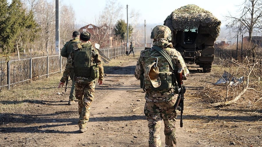 <div class="paragraphs"><p>Russian service members walk along a street in a part of the Kursk region, which was recently retaken by Russia's armed forces in the course of Russia-Ukraine conflict, Russia, in this image released March 14, 2025. </p></div>