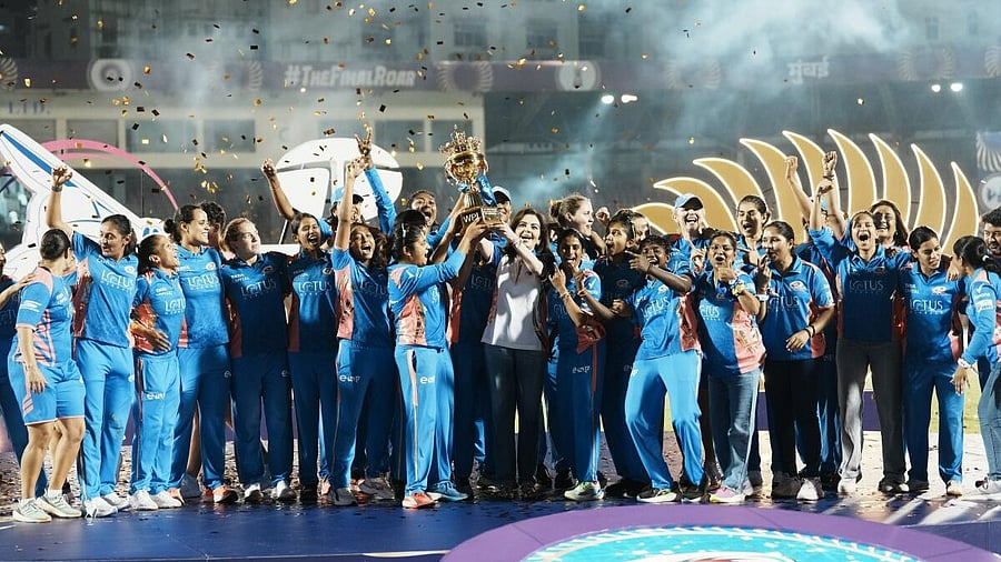 <div class="paragraphs"><p>: Mumbai Indians' owner Nita Ambani and players celebrate with the trophy after winning the Women's Premier League (WPL) 2025 final cricket match against Delhi Capitals, in Mumbai, Sunday, March 16, 2025.</p></div>