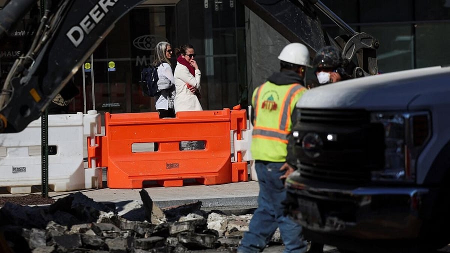 <div class="paragraphs"><p>Pedestrians watch, as workers continue to dismantle Black Lives Matter Plaza, as part of a new mural project after Congressional Republicans threatened to cut funding if the plaza was not renamed, in Washington, DC, US.</p></div>