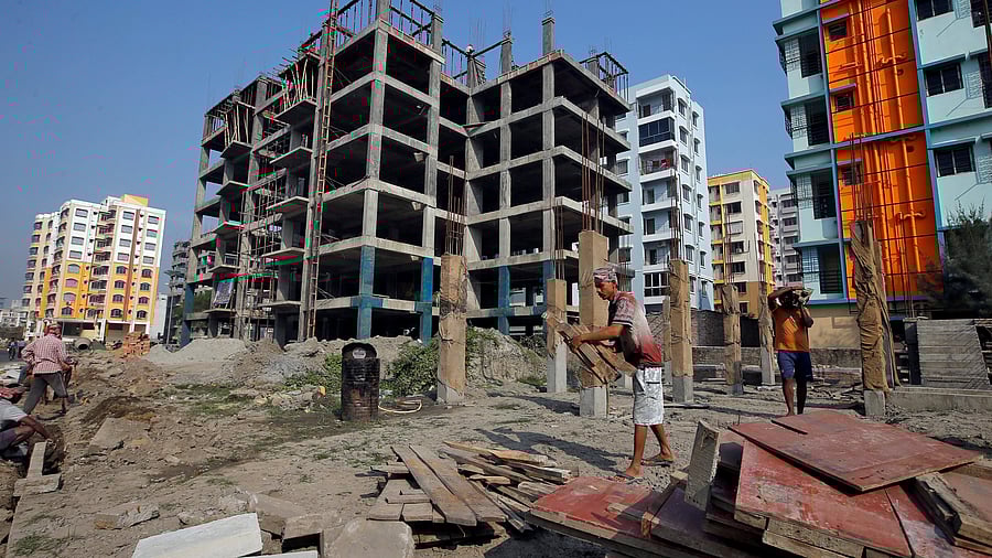 <div class="paragraphs"><p>FILE PHOTO: Labourers work at the construction site of residential buildings on the outskirts of Kolkata, India, February 1,2019. </p></div>